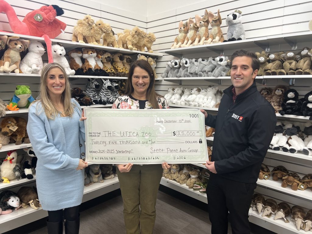 Carly Steet Mathias, left; Andria Heath, Utica Zoo Director; Joe Steet Jr., right presenting the Utica Zoo with their $25,000 donation