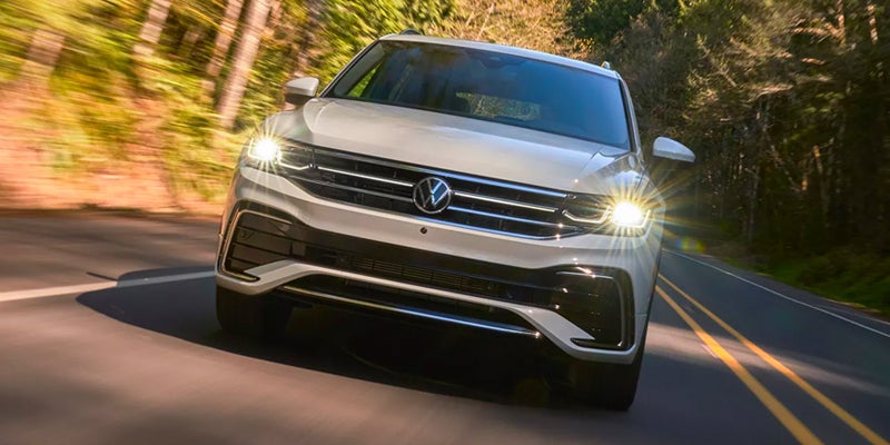 a white 2024 Volkswagen Tiguan driving up a highway fast